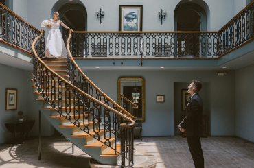 bride at top of stairs, groom at the bottom.