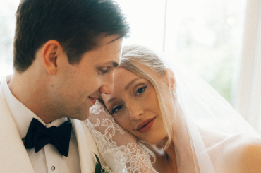 bride resting head on groom's shoulder